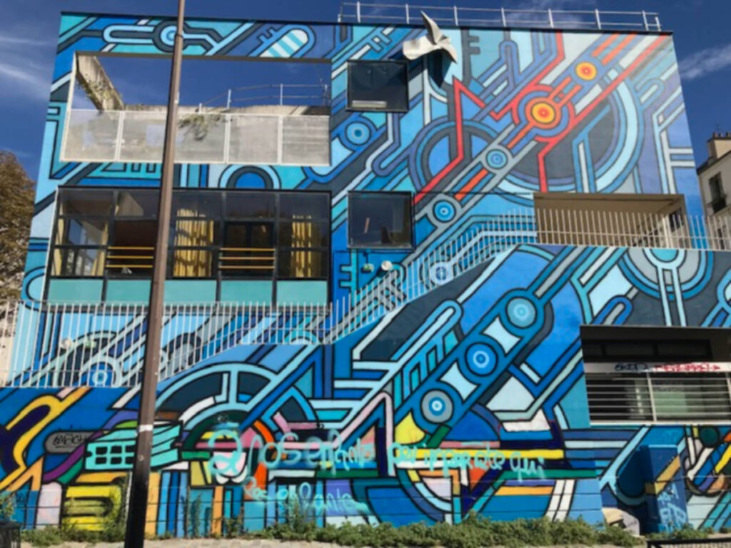 A colorful mural adorns the side of a building