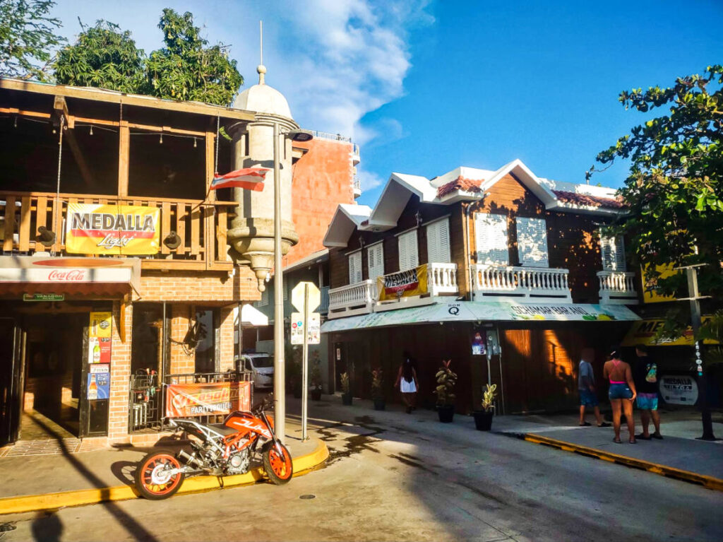 View of the people and a motorbike parked at the street in Cabo Rojo