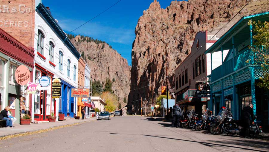 View of motorcycles parked alongside a street in Creede
