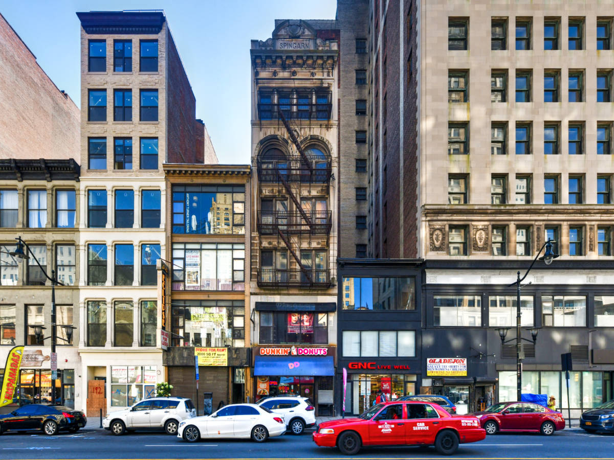 View of the shops and the cars driving in Downtown Newark