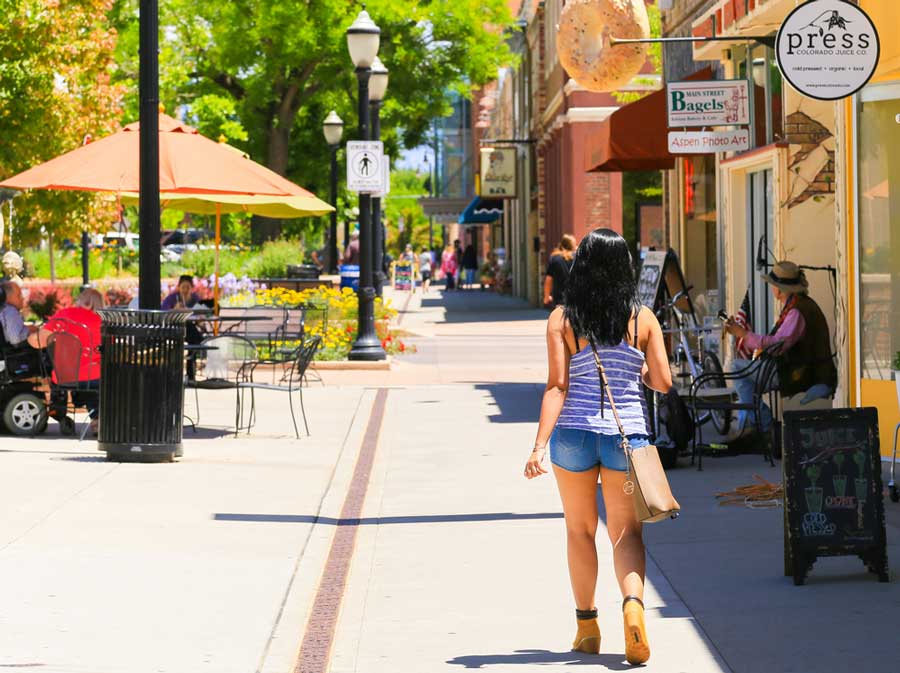 People hanging our in Grand Junction and a woman walking