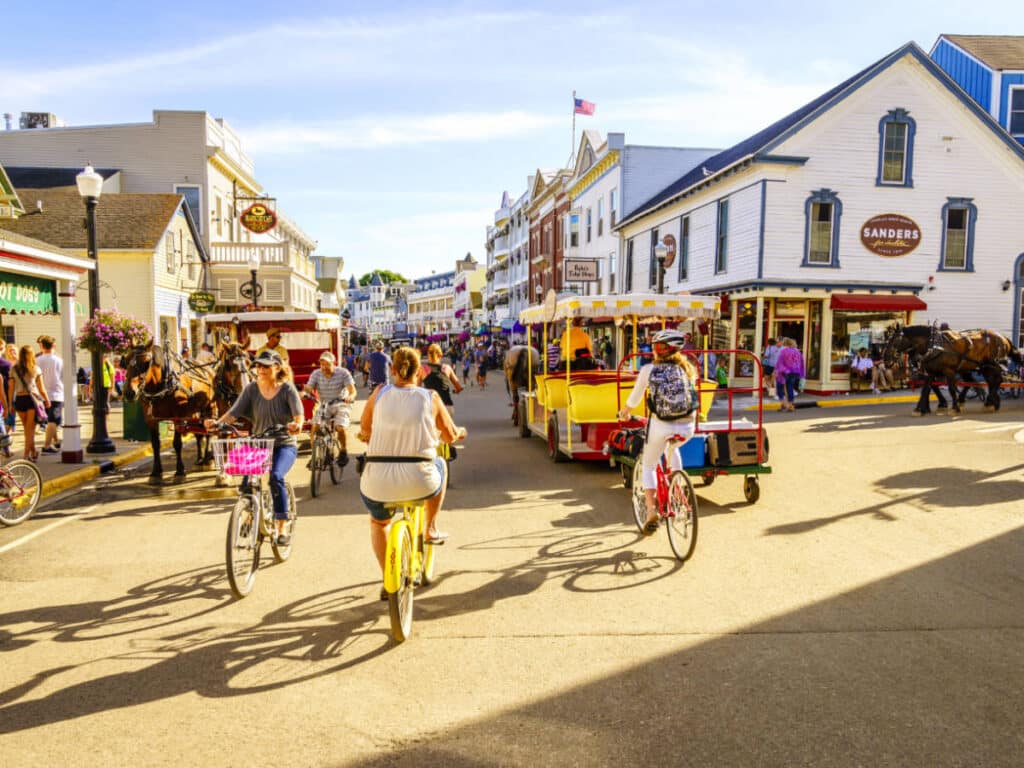People on their bicycle on a street in Mackinac Island