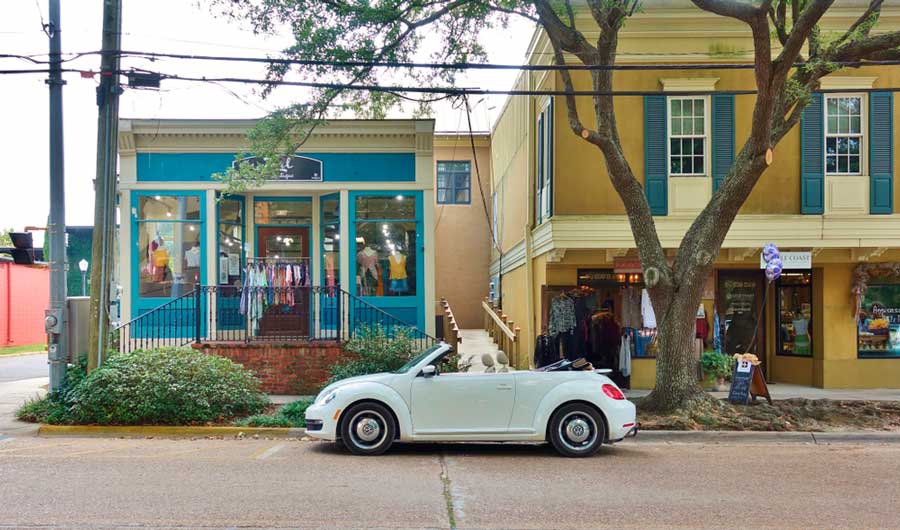 A small car parked on a street in Ocean Springs