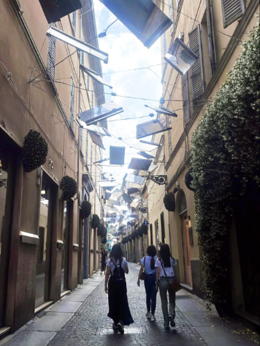 View of the people wandering around the street in Parma