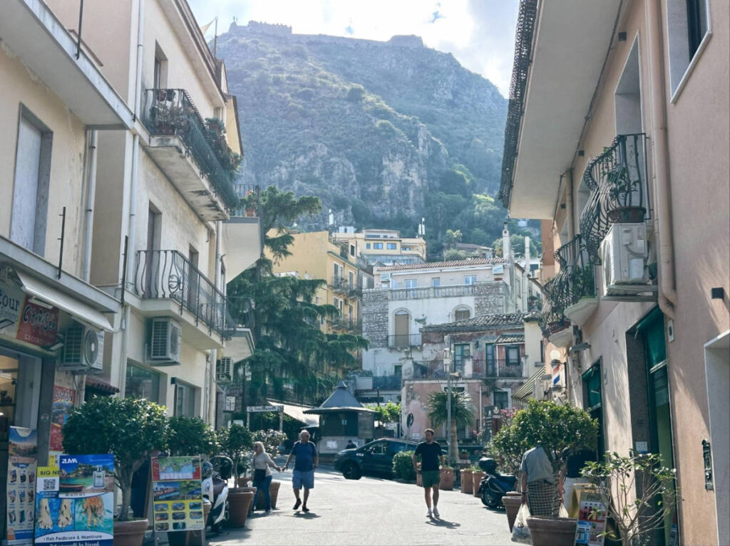Tourists walking on a street in Taormina
