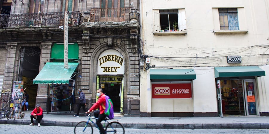 A man riding on a bicycle during the day at the street of downtown Mexico