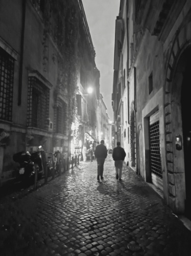 Men walking along the alleyway at night