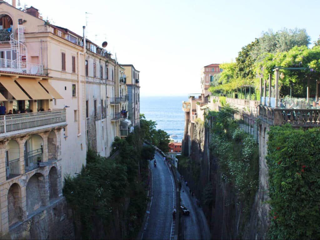 Overlooking view of a street in the middle of the tall buildings in Sorrento