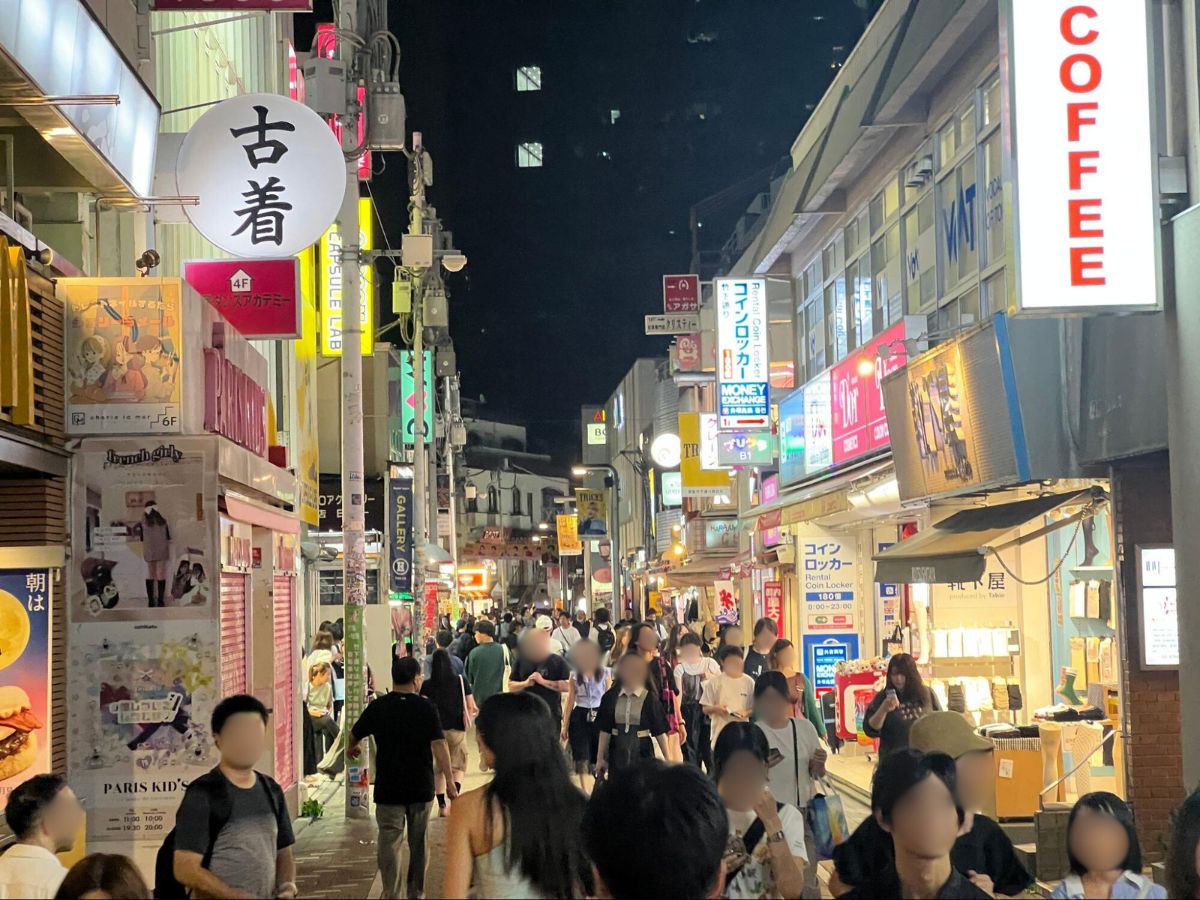Crowd of people wandering the streets of Harajuku at night