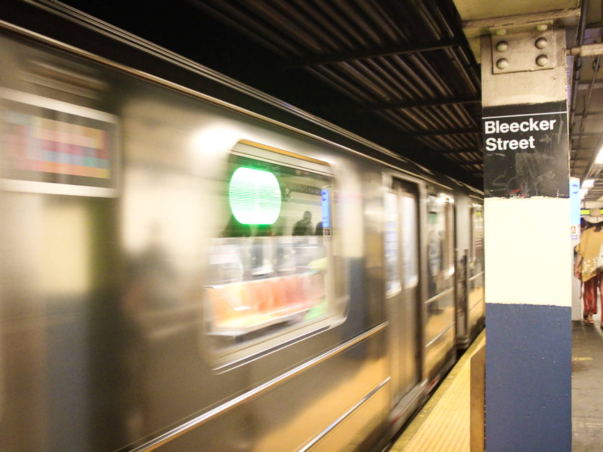 Closeup look of the subway going by at the Bleecker Street stop