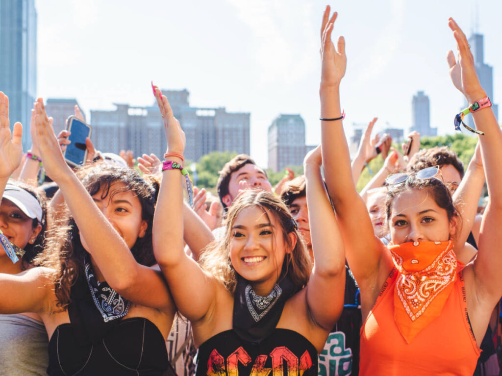 People with their hands up while enjoying the Sueños Music Festival