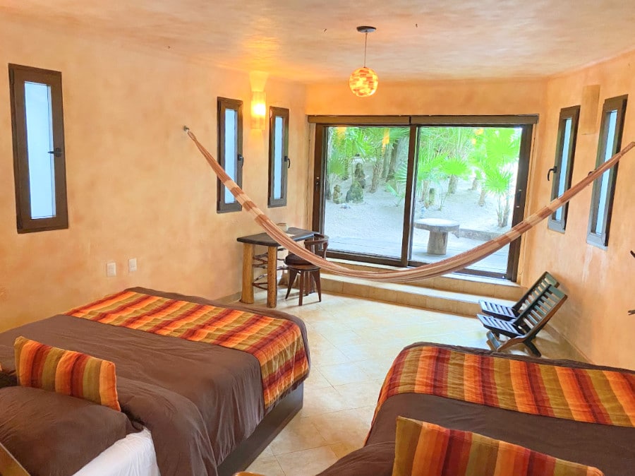View of two bed in a room with a hammock