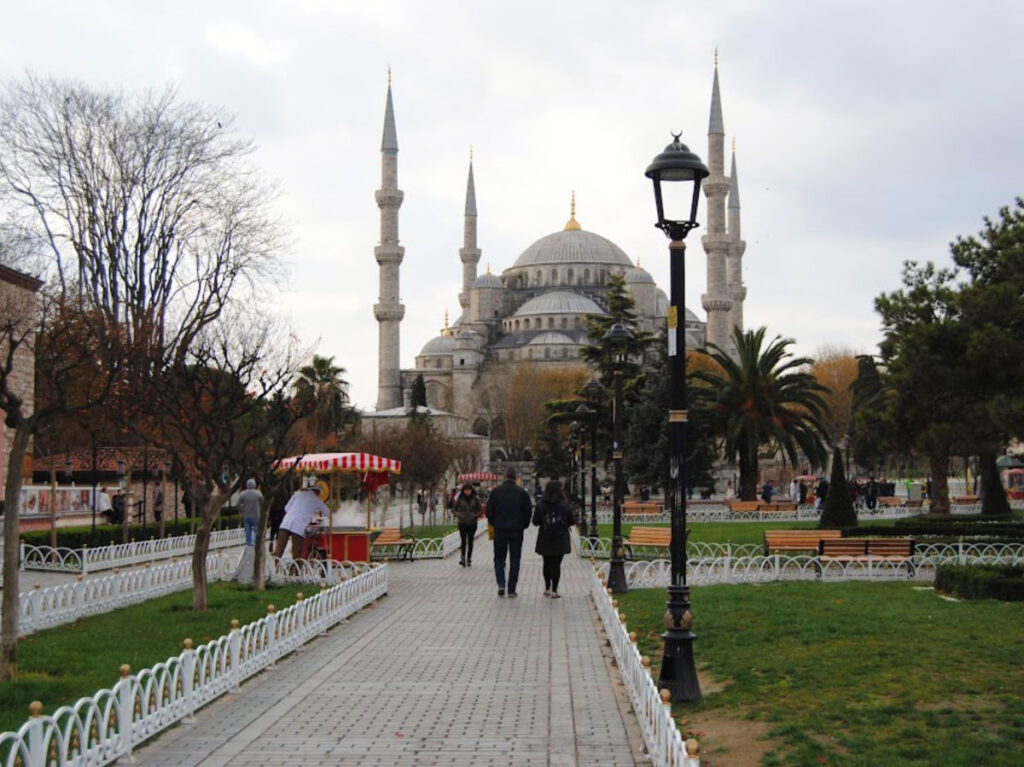 Visitors strolling by the Blue Mosque on a path at Sultanahmet Square