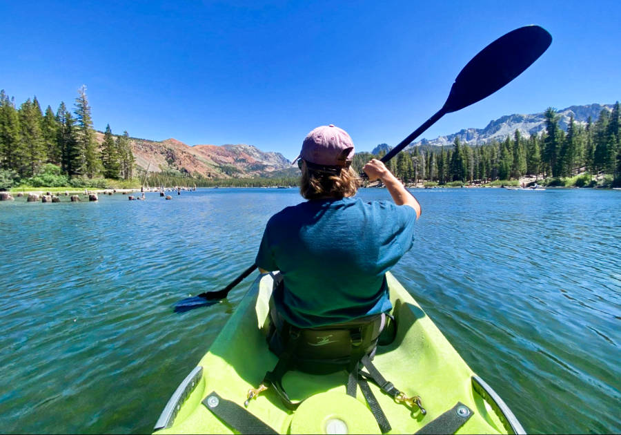 A woman kayaking on Lake Mary on a sunny day