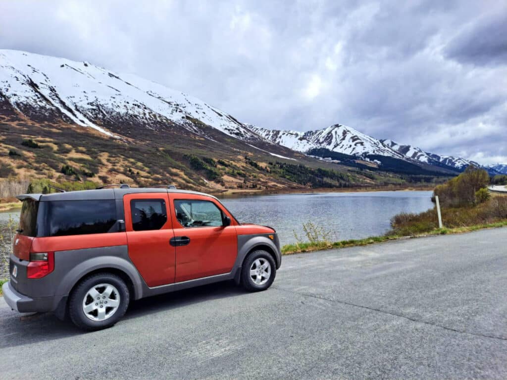 A car stopping by Summit Lake in Alaska