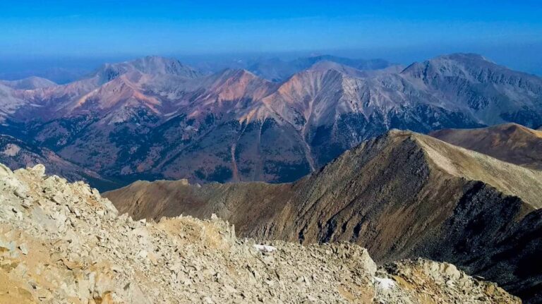 A sunny day with a scenic view of the mountain ranges from the summit of Huron Peak