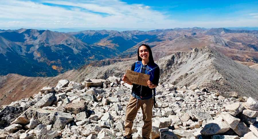 The author holding a paper on the summit of Mount Princeton