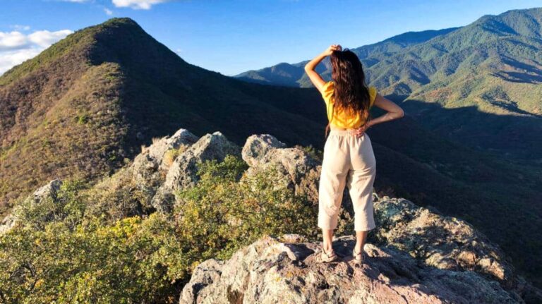 The author McKenna Mobley posing at the summit of Pueblos Mancomunados
