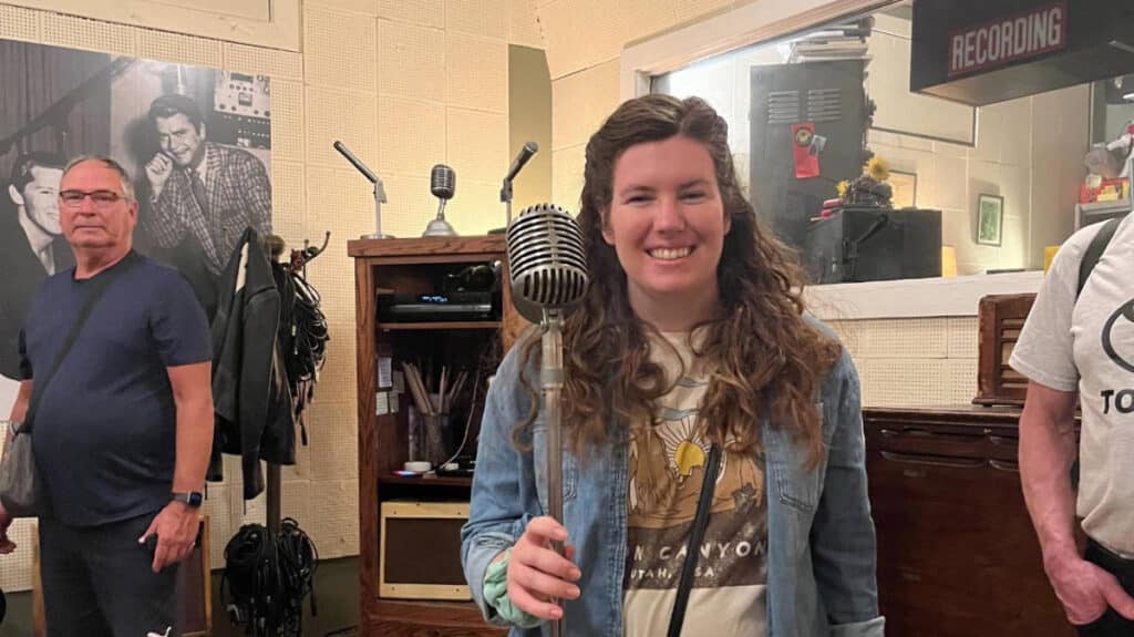 The author, Elizabeth Demolat holding a vintage mic at the Sun Studios