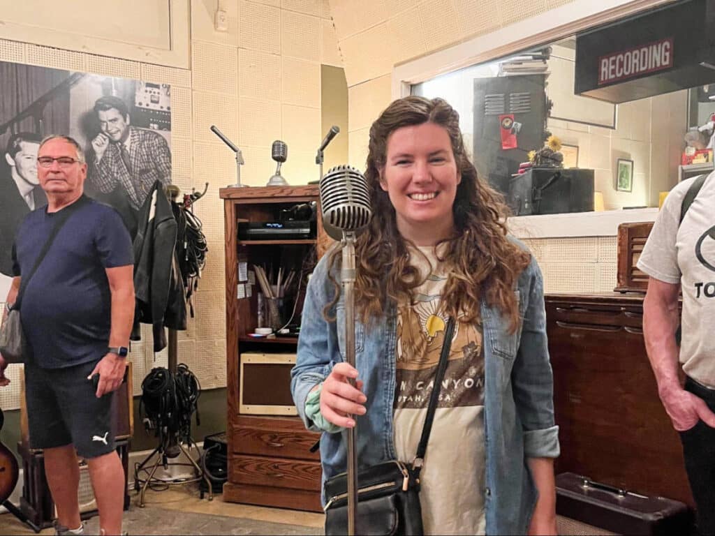 The author, Elizabeth Demolat smiling for a photo inside a Sun Studio