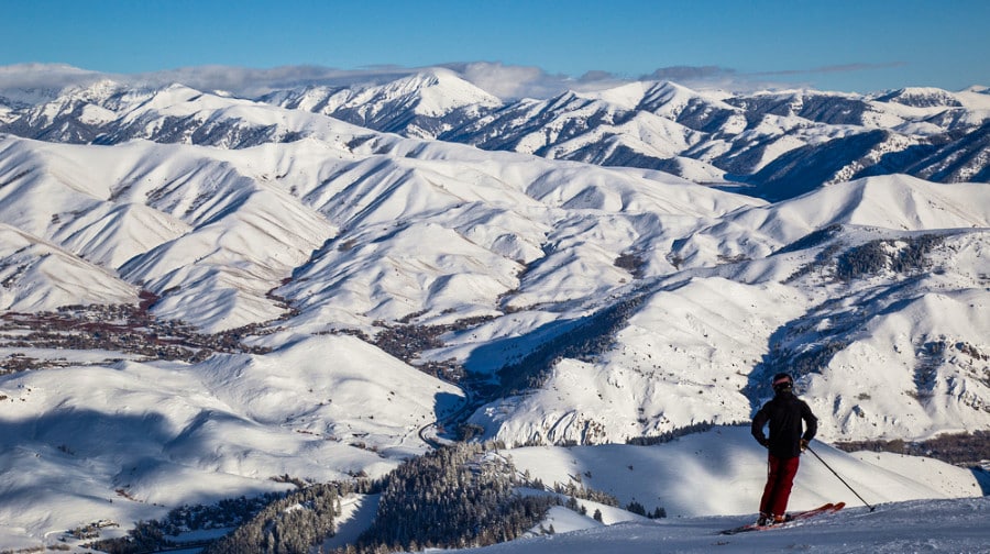 A man skiing down the snow covered mountains in Sun Valley in winter.