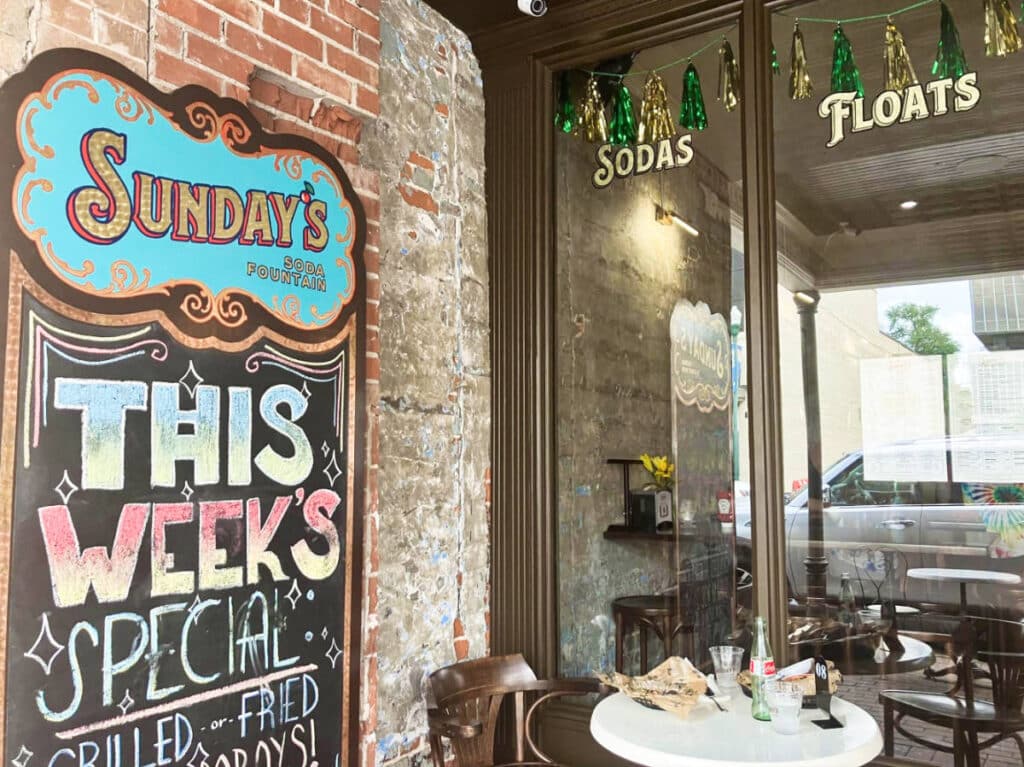 View of the outdoor seating area at the storefront of Sunday’s soda shop and ice cream parlor in Downtown Lafayette