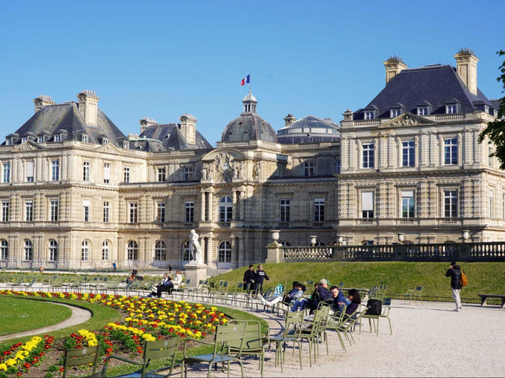 People relaxing on a sunny day in the Paris Luxembourg Garden