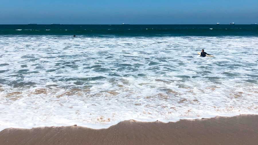 View of people with their surfboard on Sunset Beach