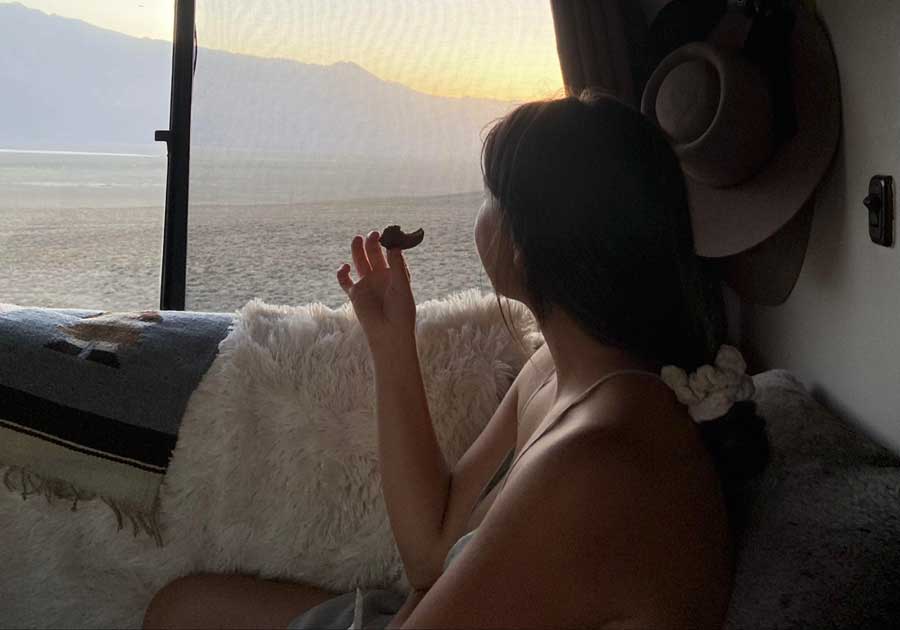 The author's friend admiring the sunset while eating a cookie