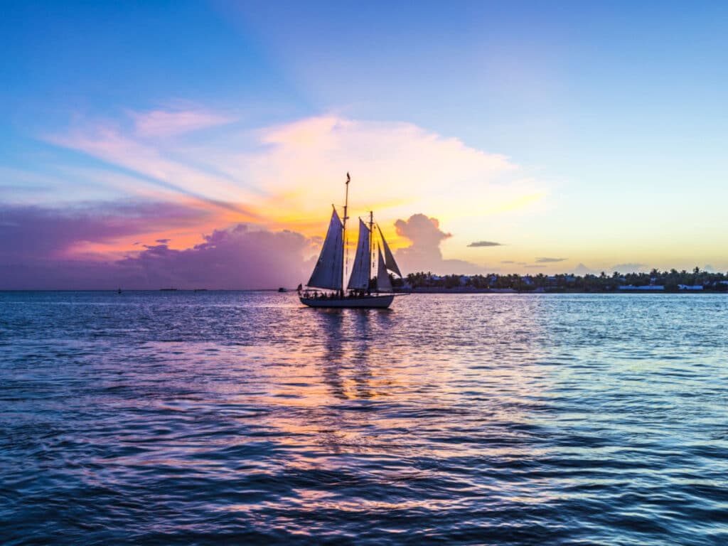 A boat sailing in Key West at sunset