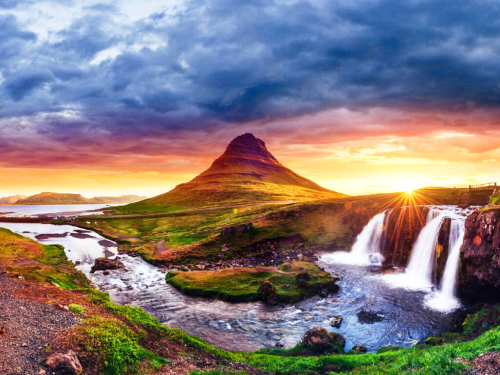 Picturesque view of the sunset over the mountain and waterfalls