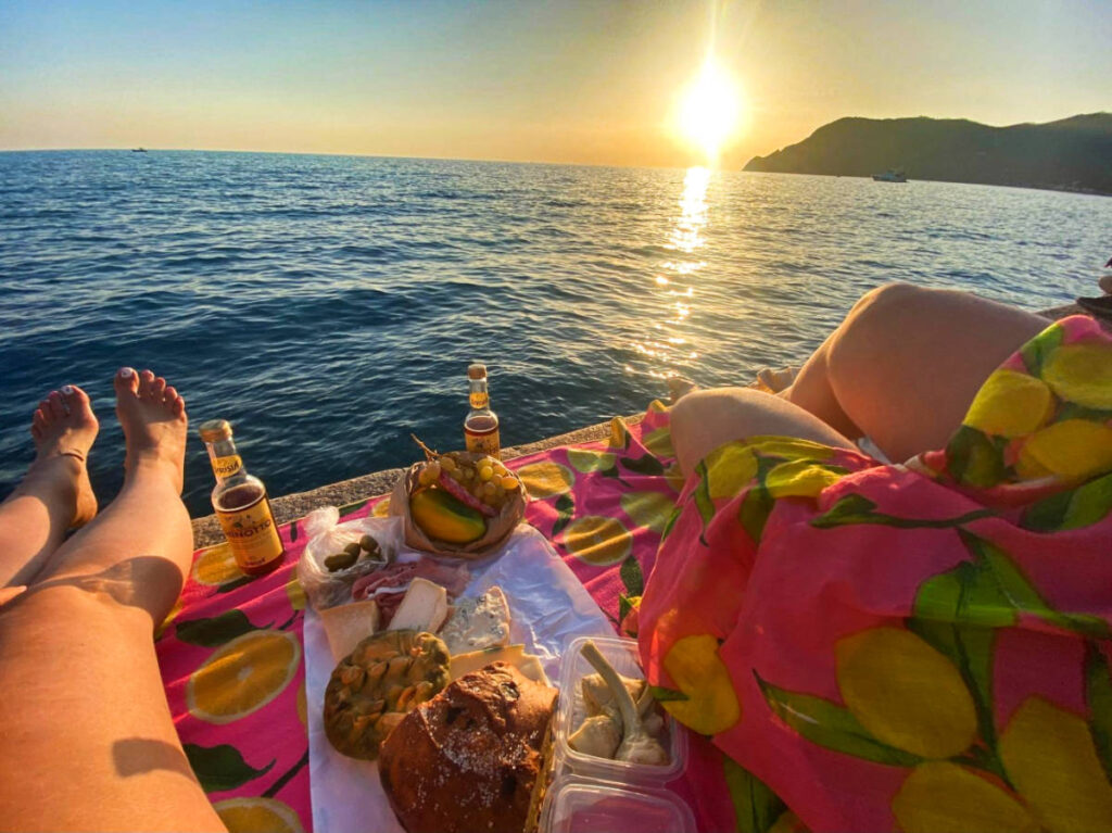 A picnic spread with ocean sunset views