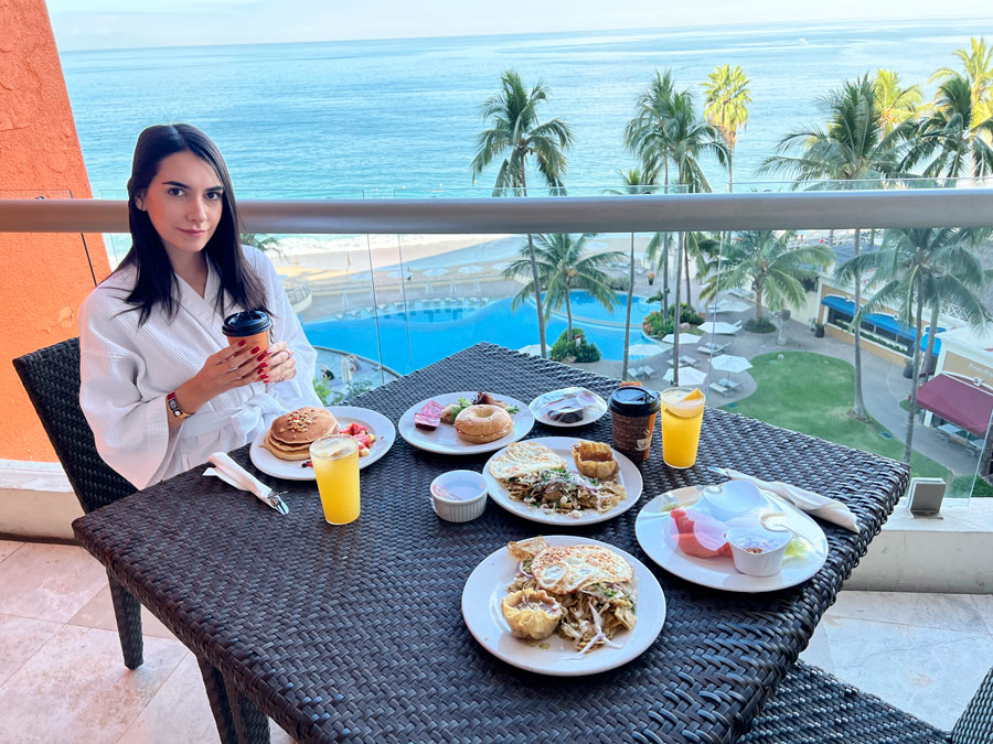 Clara on the balcony with meals on her table
