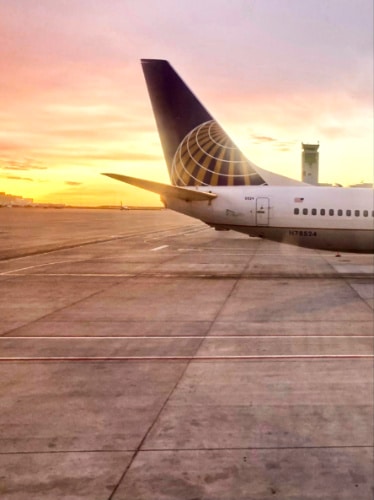 Scenic sunset view behind the airplane at Denver International Airport