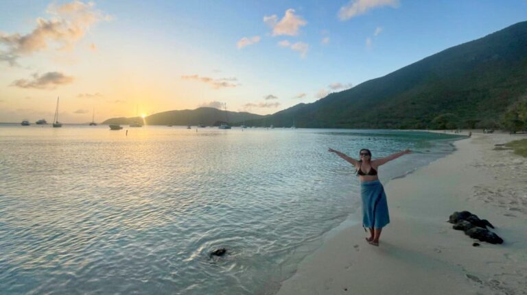 The author's wife admiring the sunset views at the shoreline in Charlotte Amalie