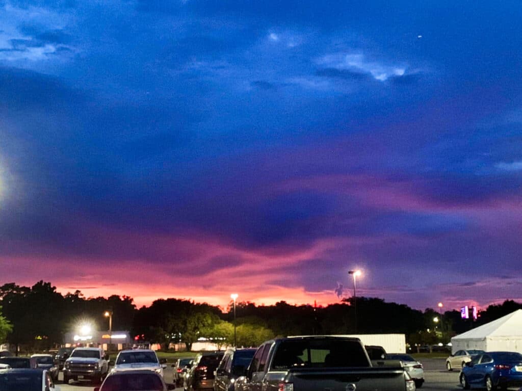 View of the sunset over the Orange Park with vehicles around
