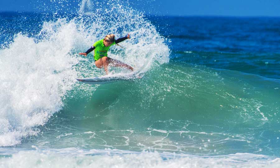 View of a woman competitor surfing in Oceanside