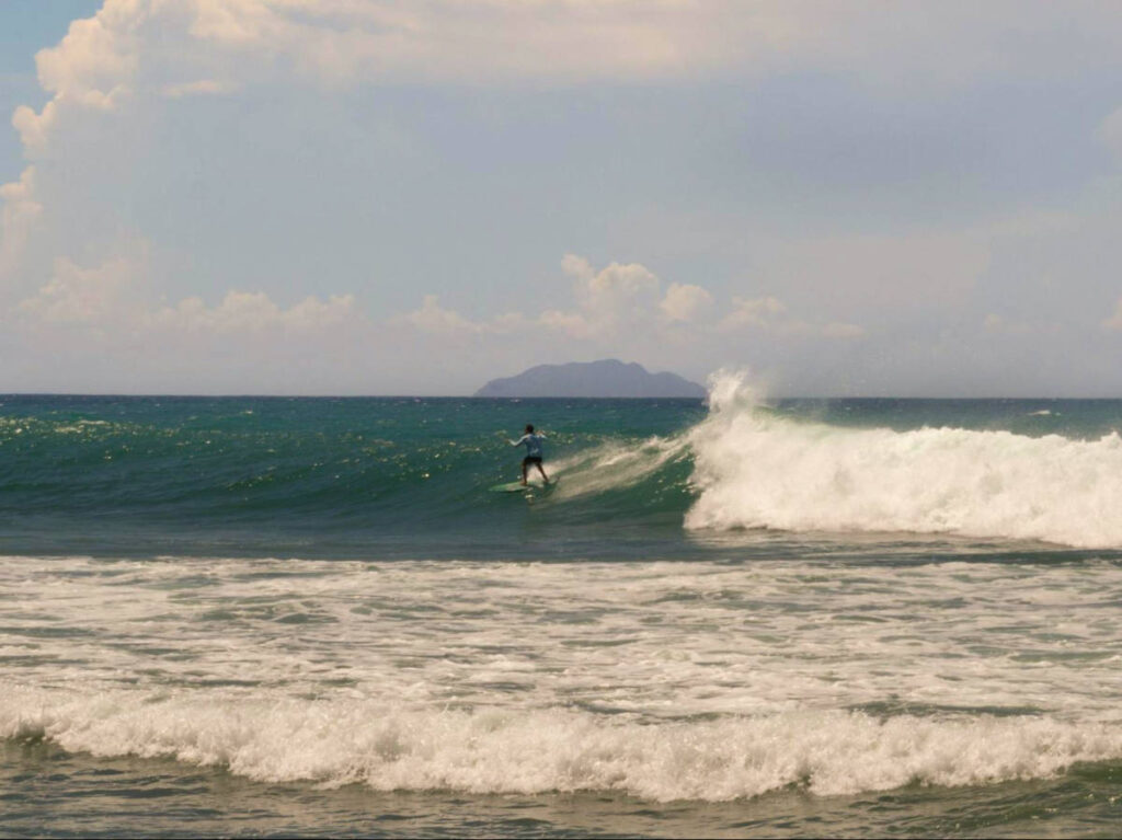 A man surfing at Domes Beach