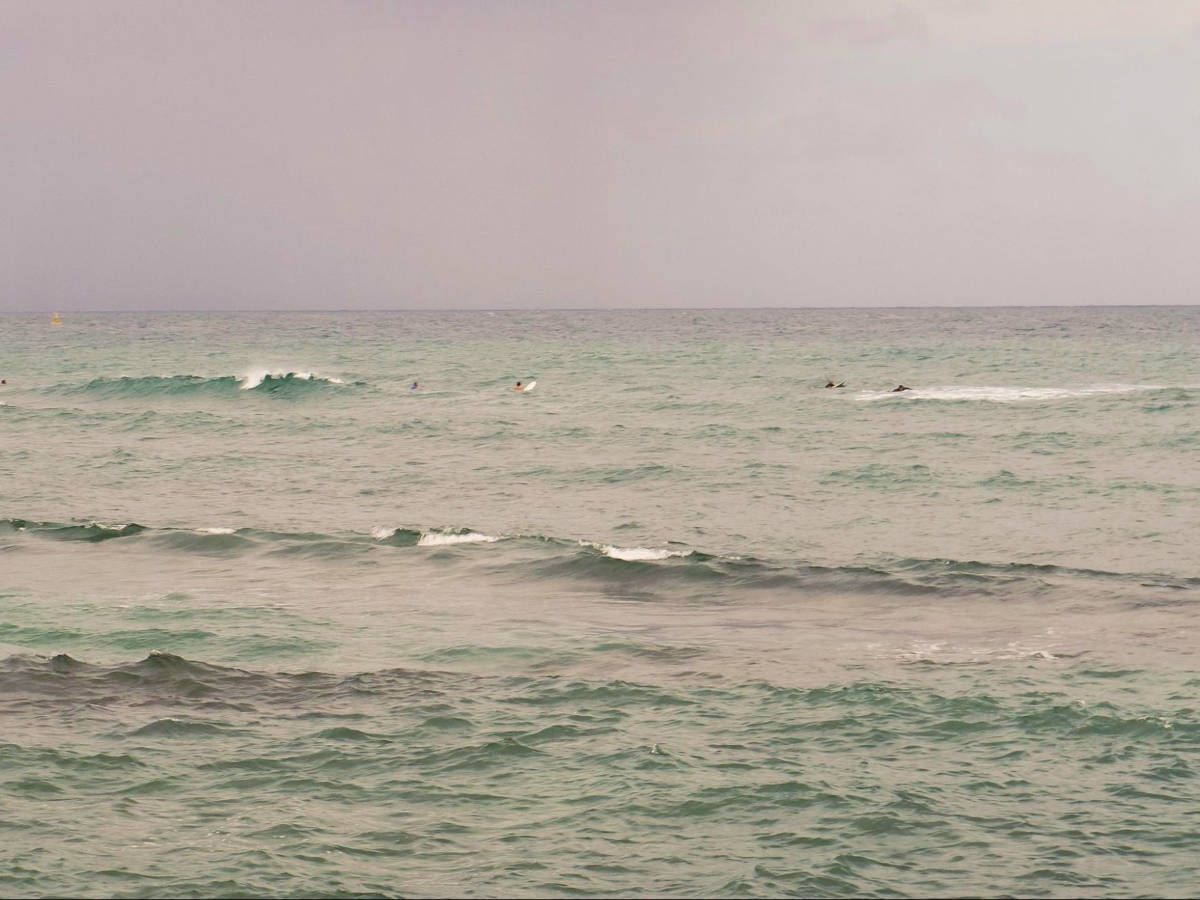 View of the surfers in the middle of the ocean of La Ocho
