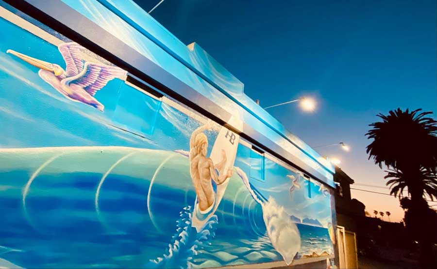 A mural of a man surfing in Huntington Beach