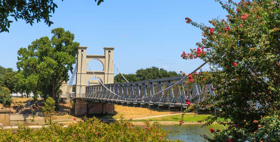 A suspension bridge under the clear blue sky in Waco, Texas