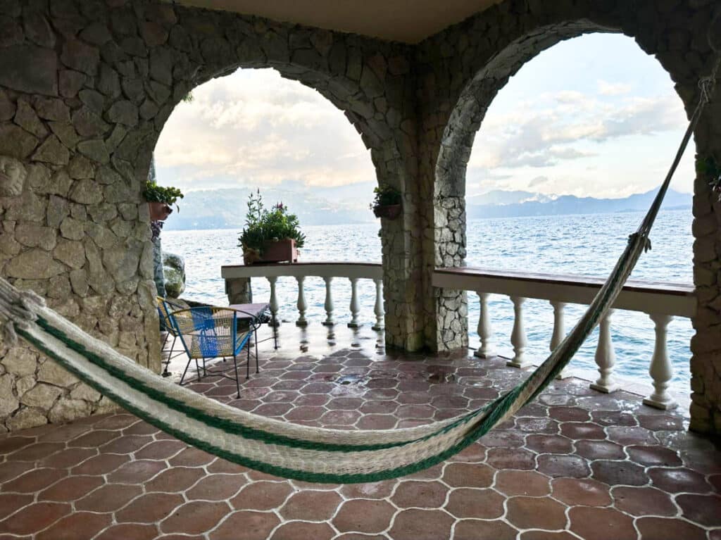 A swing and an outdoor seating area at the balcony of La Casa del Mundo