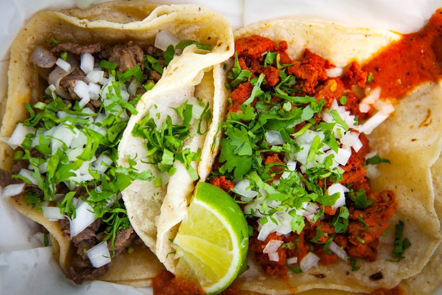 View of a mouthful tacos from Tacos El Papi