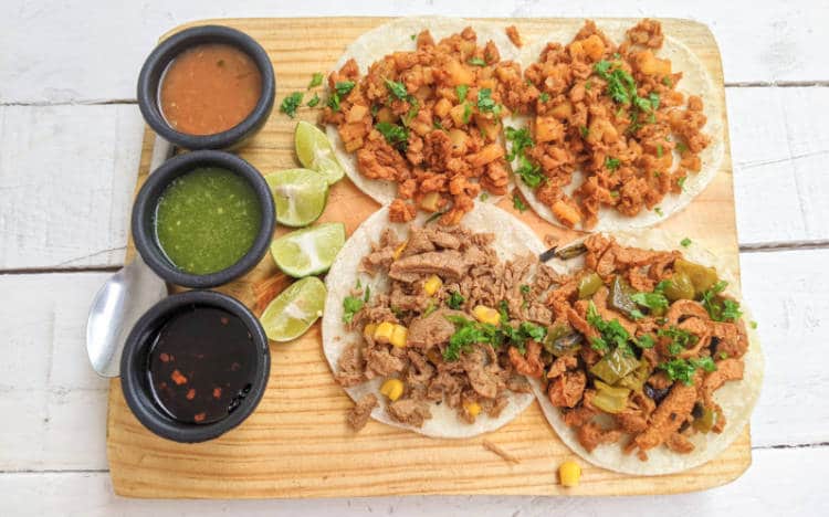 A plate of tacos and salsas