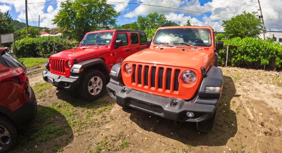 Two red and orange island jeeps in St. Croix