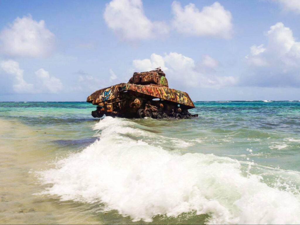 The iconic painted tank at the shoreline of Flamenco Beach