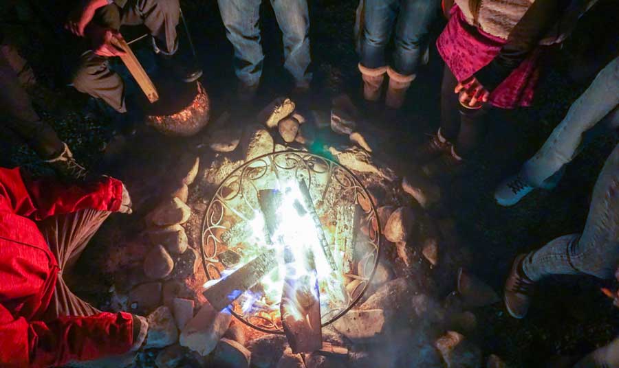 View of people around a fireplace in Taos Mesa Brewing
