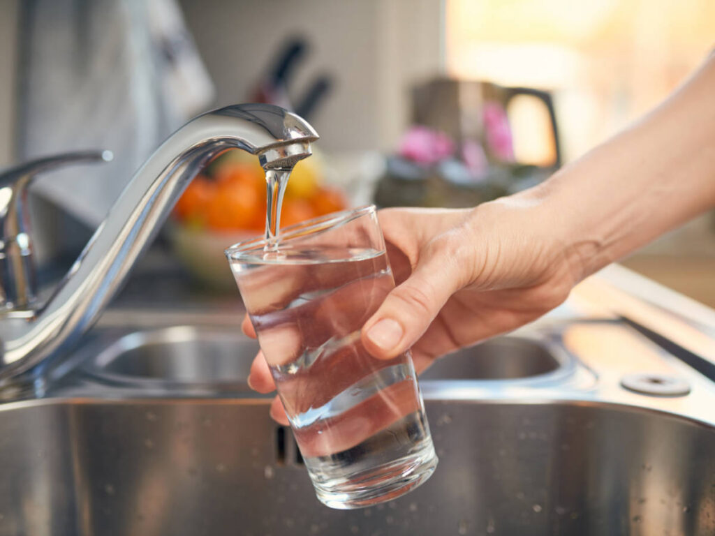 Pouring tap water on a glass