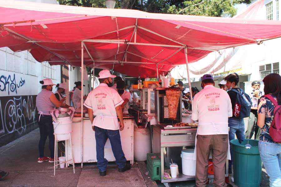 People buying from a Taqueria Miranda food stand in Mexico City