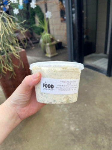 Holding a Tarragon Almond Chicken Salad on a to-go case